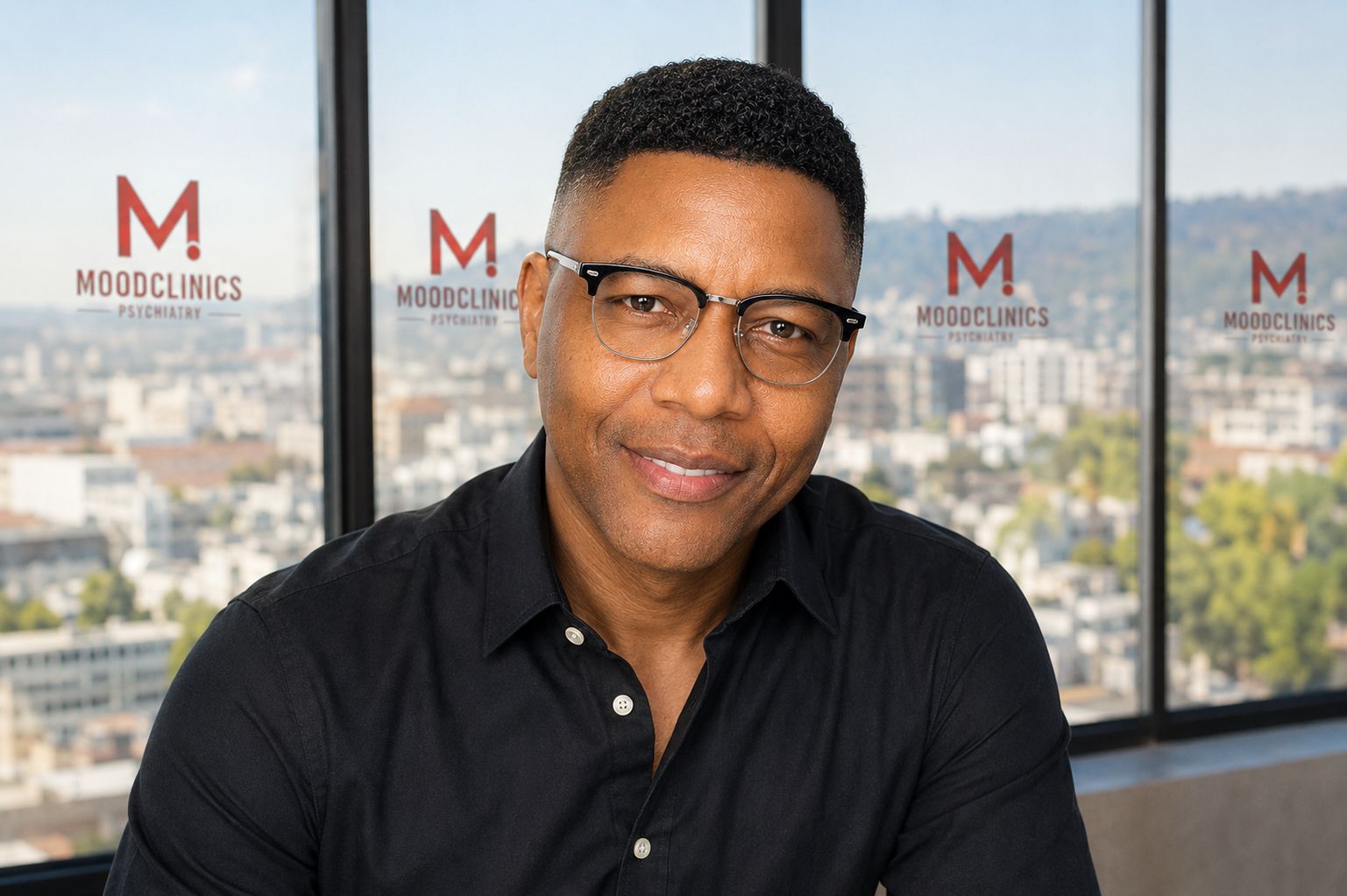 Portrait of Hughes Mohlie with Moodclinics signs in the background